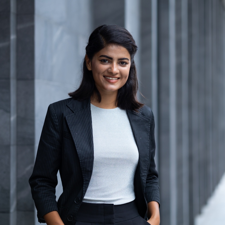 Indian Asian business woman - Portrait Smiling Young Businesswoman in black suit at outside modern office building. Positive human emotions