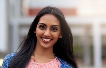 College student, portrait and happy at university for scholarship and learning at campus for summer. Indian woman, smile and outdoor for class schedule or update, back to school and gen z at academy