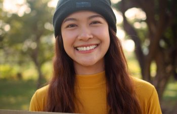 Go green culture Gen z asia people young adult woman curly hair enjoy cheerful relax toothy smile happy face looking at camera nature tree public park save the earth eco friendly city life future hope