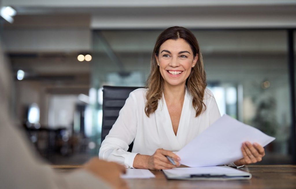 Professional woman holding documents during an interview meeting